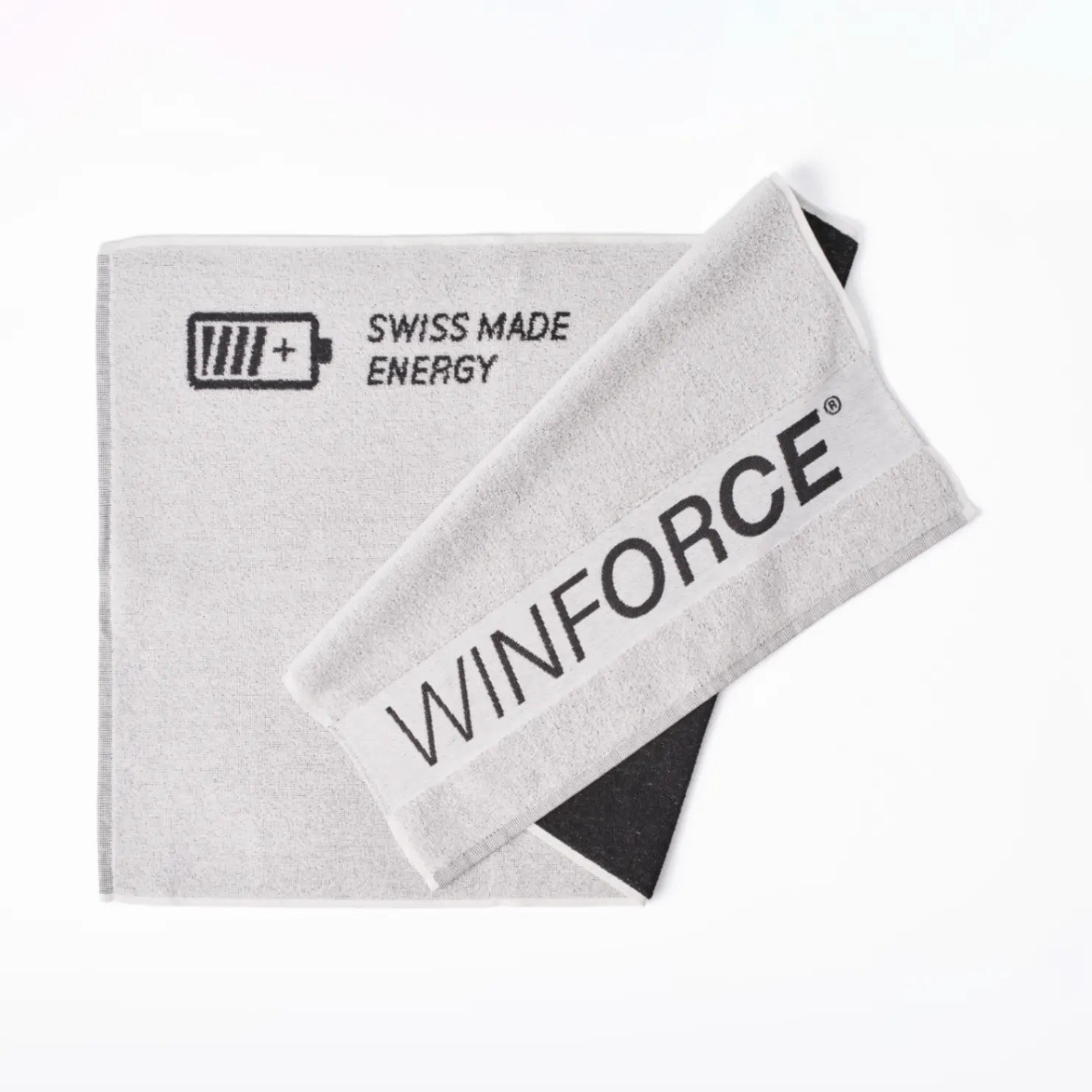 Ein hellgraue Winforce Sporthandtuch auf weißem Hintergrund, mit einem Batterielogo und „SWISS MADE ENERGY“ Schriftzug, sowie „WINFORCE®“ Logo, perfekt für das Training.